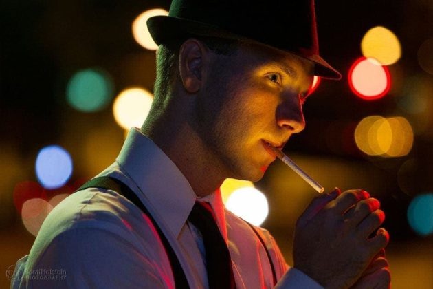 Narrative portrait photography sample featuring a detective in a fedora lighting a cigarette.