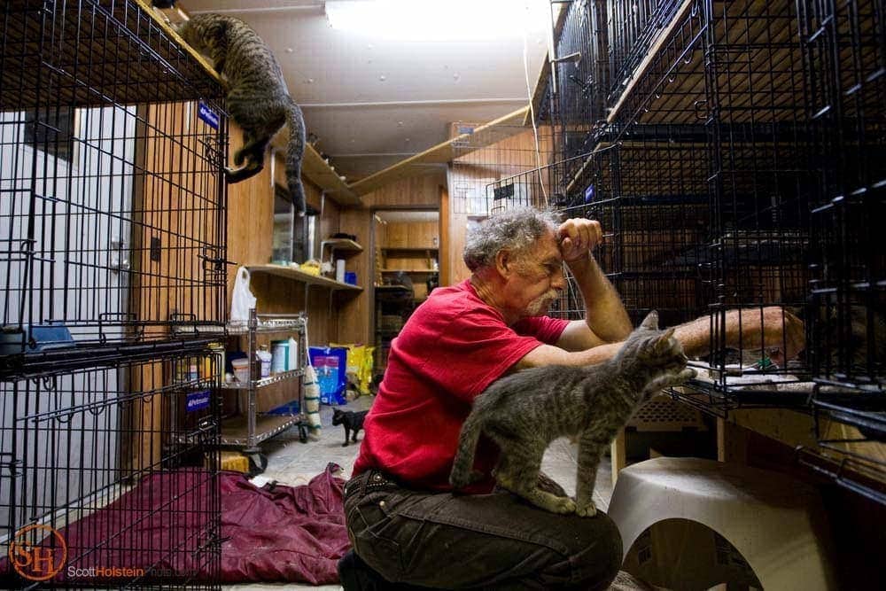 Photo of Craig Grant caring for an injured cat in Florida by editorial photographer Scott Holstein.