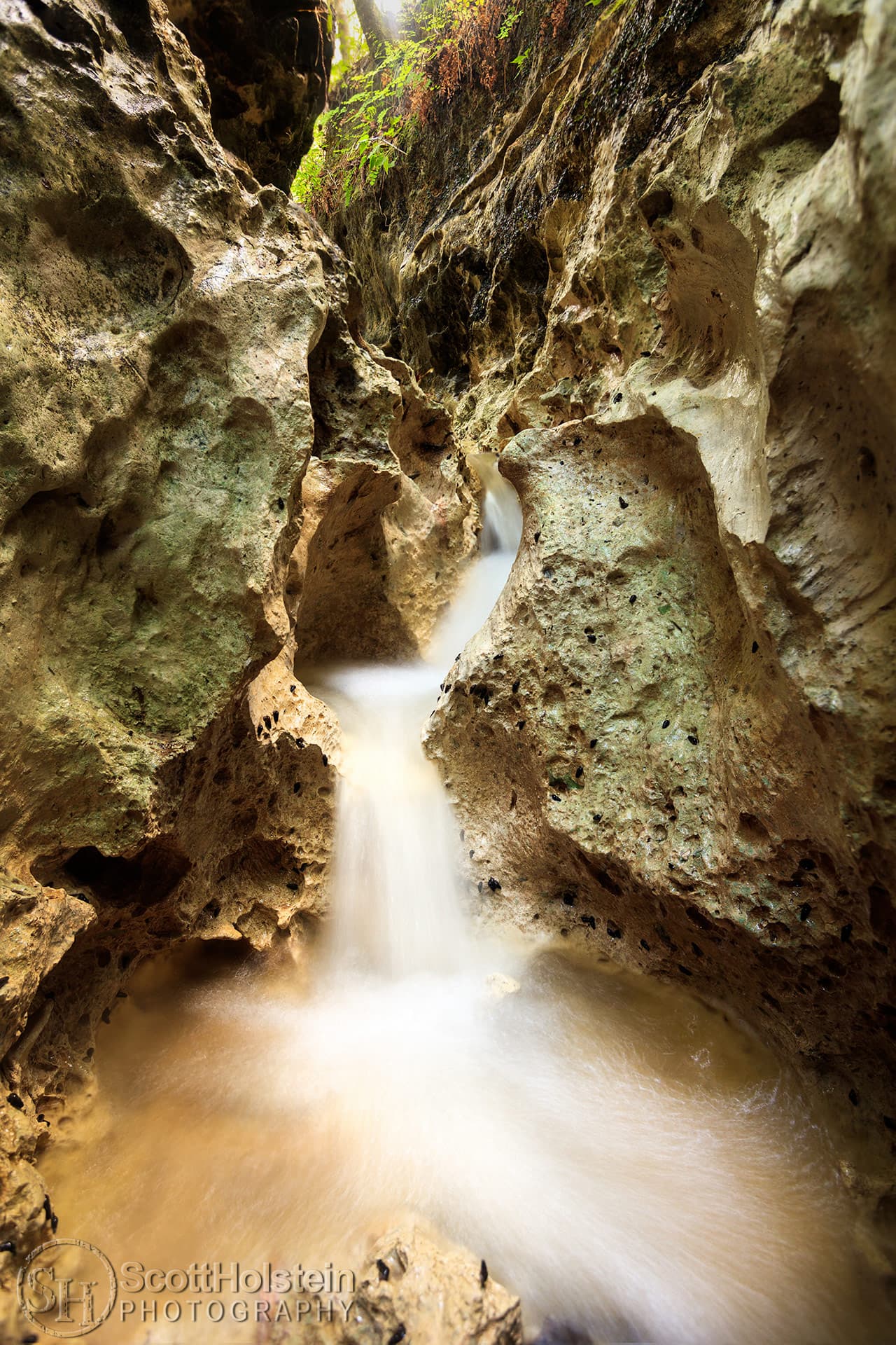 Florida Slot Canyon 1 landscape prints for sale: Water from a small creek cascades over limestone at the bottom of a narrow slot canyon.